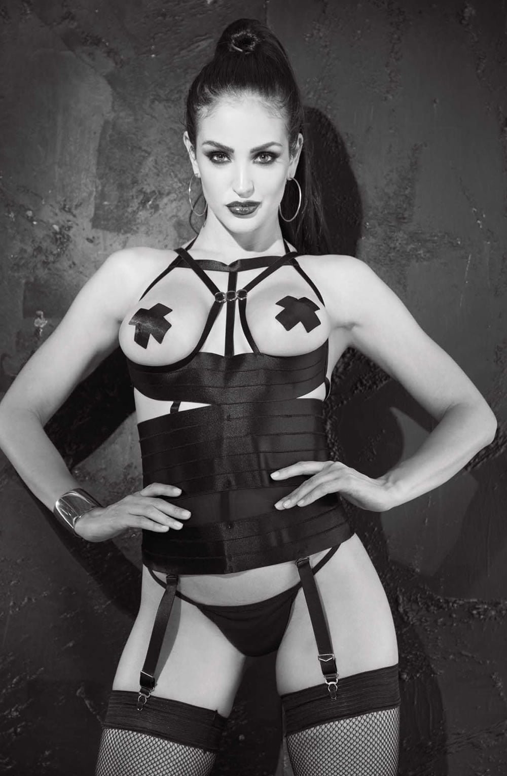 Shirley of Hollywood open bust black bustier with strappy design, garter straps, and fishnet stockings