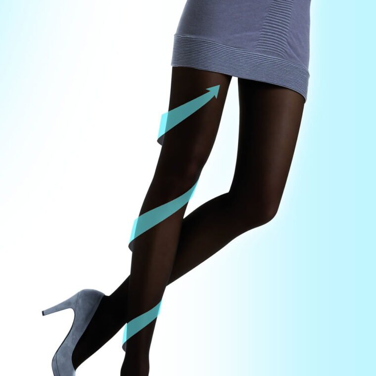 Control Body shaping tights in antilope shade worn with grey dress and high heels, spiral arrow graphic on legs