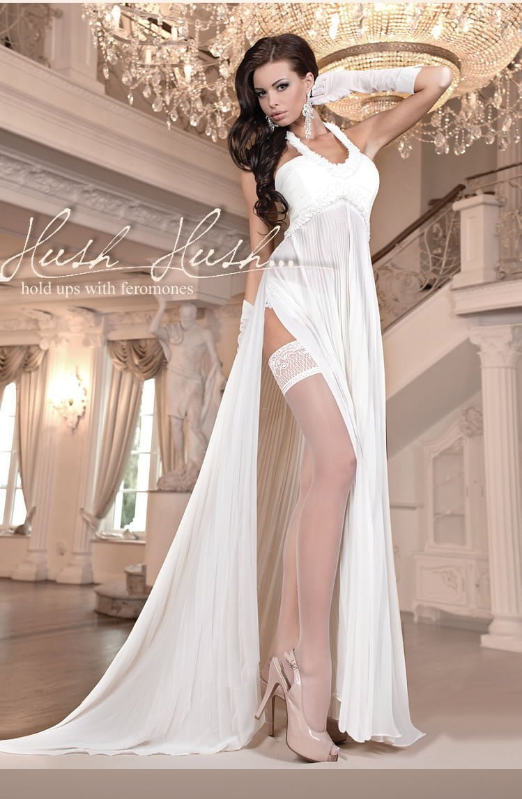 Ivory hold ups with lace top worn with long white gown and high heels in elegant interior