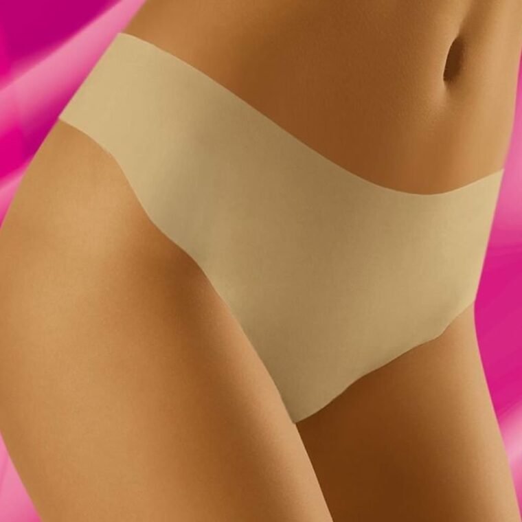 Wolbar Elcanta beige thong with seamless design shown on model against pink background